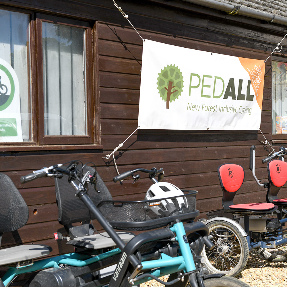 A PEDALL banner hang up at the Burley location with tandem bikes below it